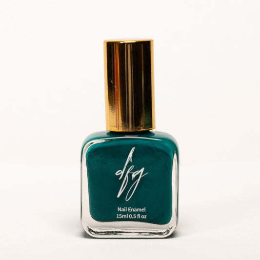 In this captivating photo, we showcase a bottle of dark green nail polish that exudes elegance and sophistication. The nail polish bottle features a sleek design, with a smooth texture that can be easily identified by touch. The color of the nail polish is a deep and rich shade of dark green, reminiscent of lush forests and timeless beauty.