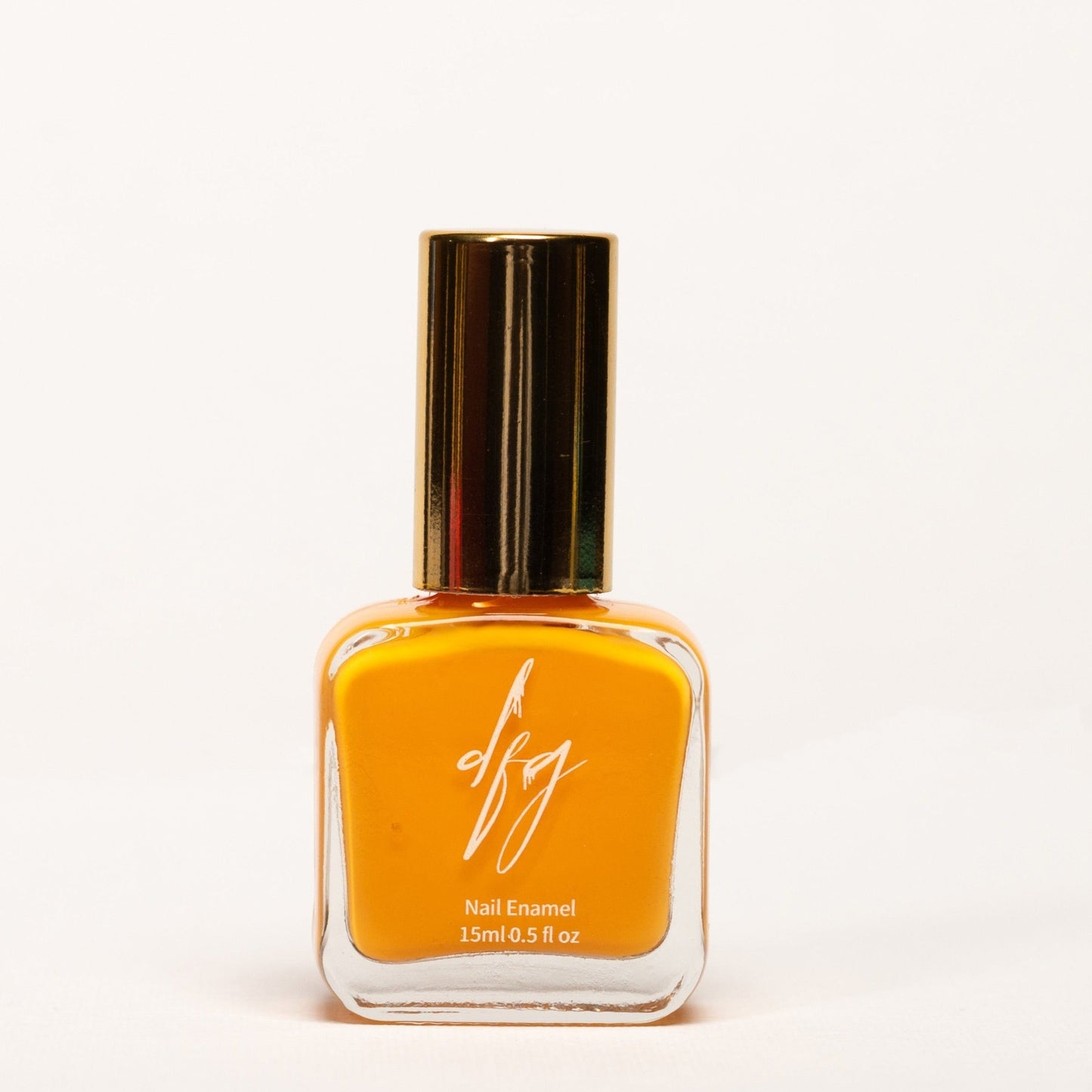 In this photo, we present a bottle of orange nail polish that embraces inclusivity and accessibility. The nail polish bottle is sleek and modern, featuring a smooth texture for easy identification by touch. The color of the nail polish is a vibrant and energetic orange, reminiscent of warm sunsets and radiant energy.